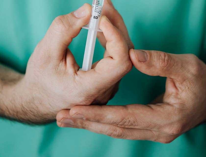 A nurse holding a syringe.