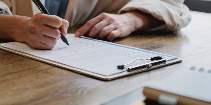 A woman writing a chronological CV.