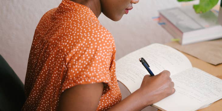 A woman writing a cover letter.