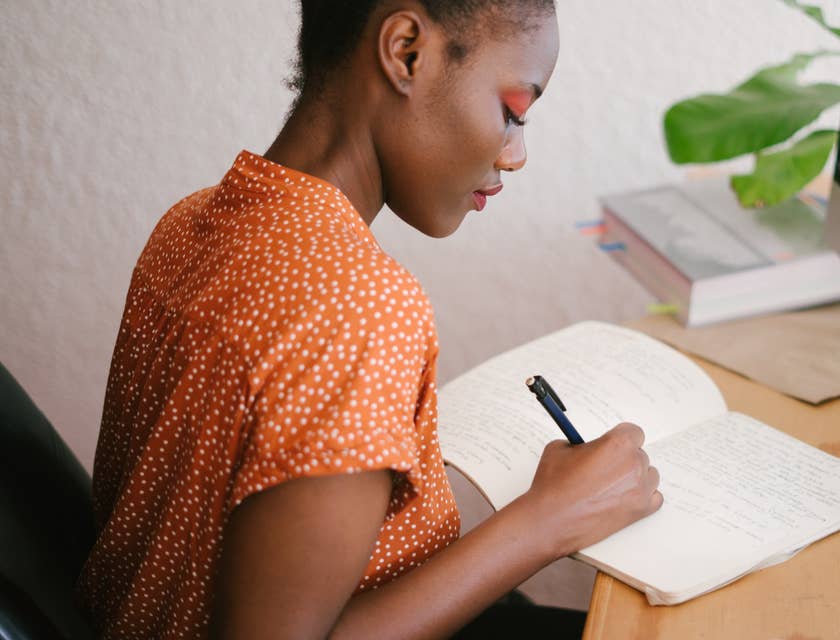 A woman writing a cover letter.