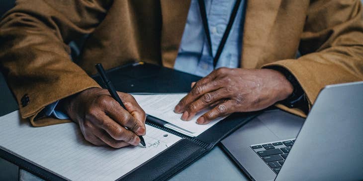 A man writing a CV.