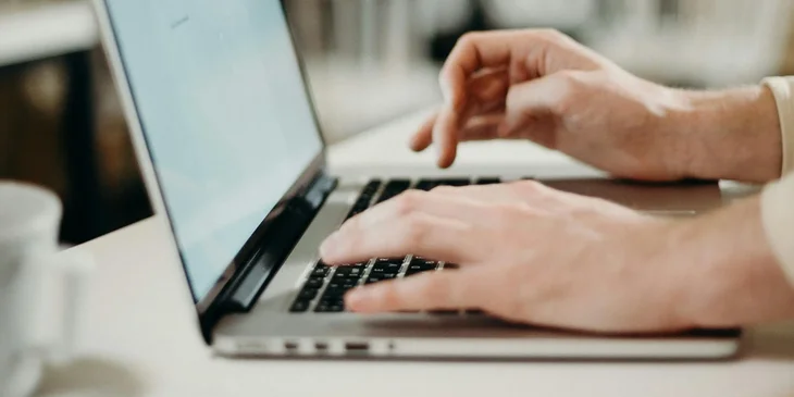 A person writing an email to a hiring manager.
