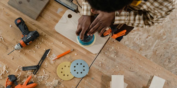 A wood finisher working on wood.