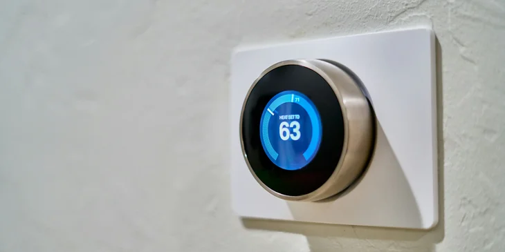 A thermostat installed by an HVAC technician, used to control heating and air conditioning.
