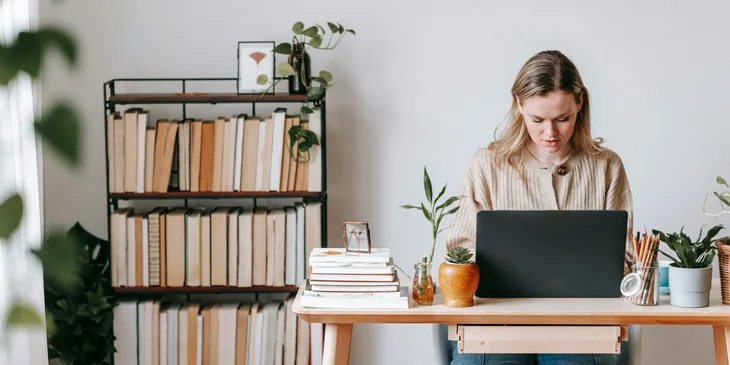 A woman working on her laptop.