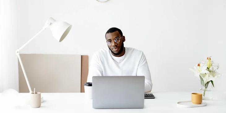 A man sitting at his work desk.