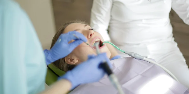 A dentist treating a patient's teeth.