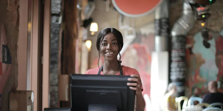 A cashier standing behind the counter.