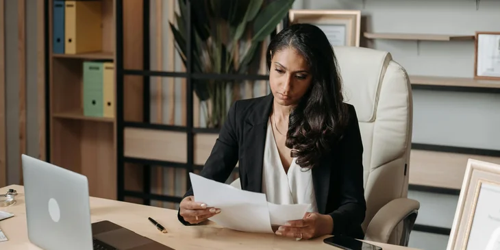 A female immigration paralegal reviewing the visa petition documents.