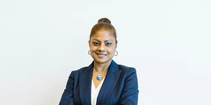 A woman in a blue blazer at work.