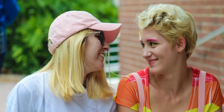 Two women sitting while talking to each other.