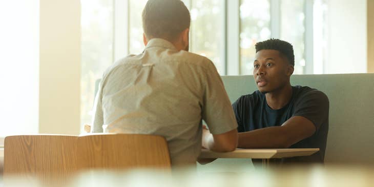 coworkers sitting opposite each other engaged in a serious meeting