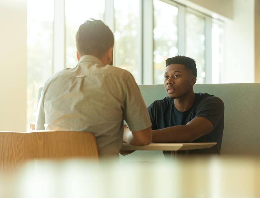 coworkers sitting opposite each other engaged in a serious meeting