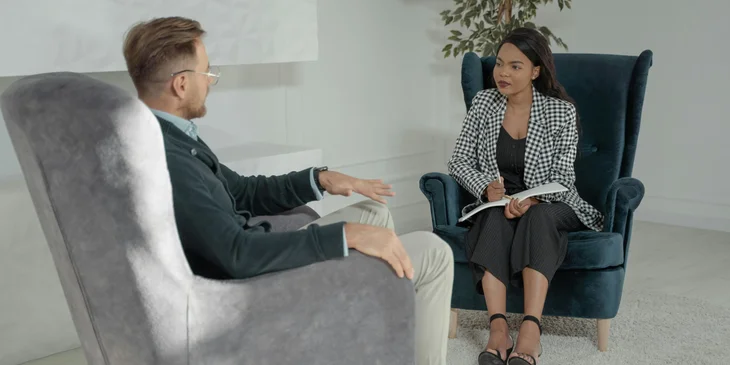 A journalist interviewing a man who is a key source of information in a case.