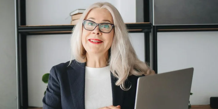 A woman holding a laptop.