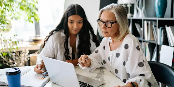 The women looking at a laptop.