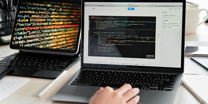 An IT person using a laptop.