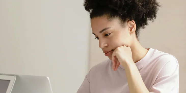 A woman using a laptop.