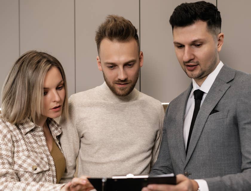 Business colleagues filling out a job requisition form.