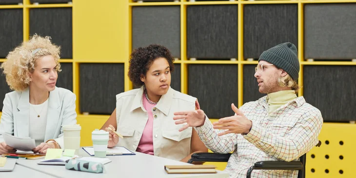 Coworkers engaged in a lively conversation in the office.