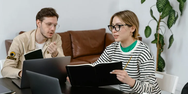 A man and a woman discussing in workplace.