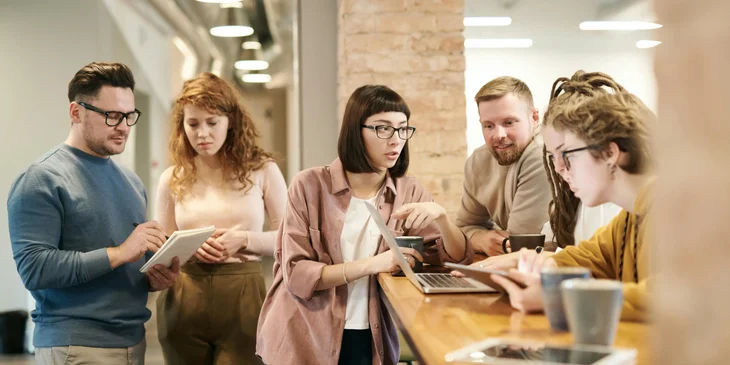Coworkers engaging in a conversation at the office.