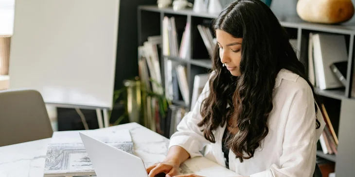 A woman sitting at her desk, working.