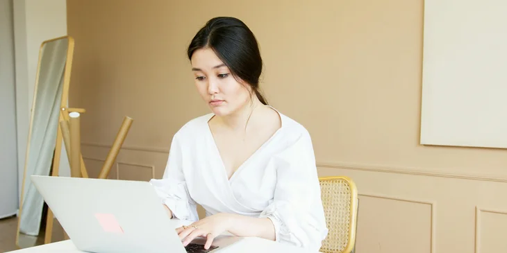 A woman working on her laptop.