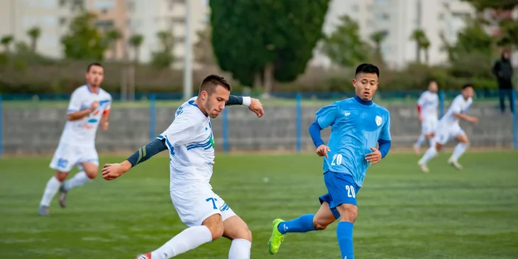 Players playing soccer on the field.
