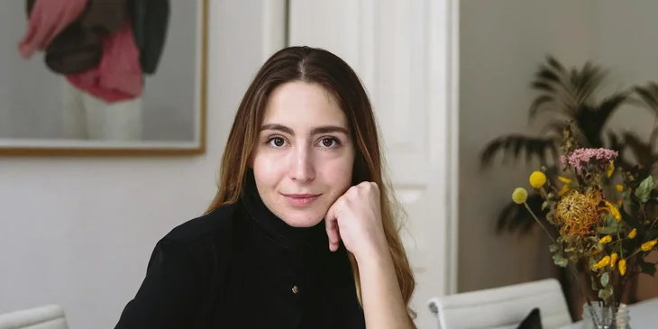 A woman looking at the camera and smiling.