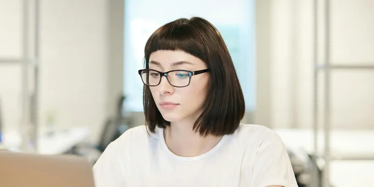 A woman using a laptop.