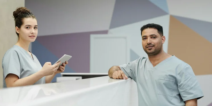 Two receptionists working at the dental clinic.