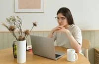 A woman reviewing a document on her laptop.