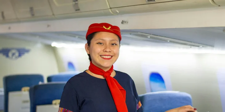 A flight attendant smiling.