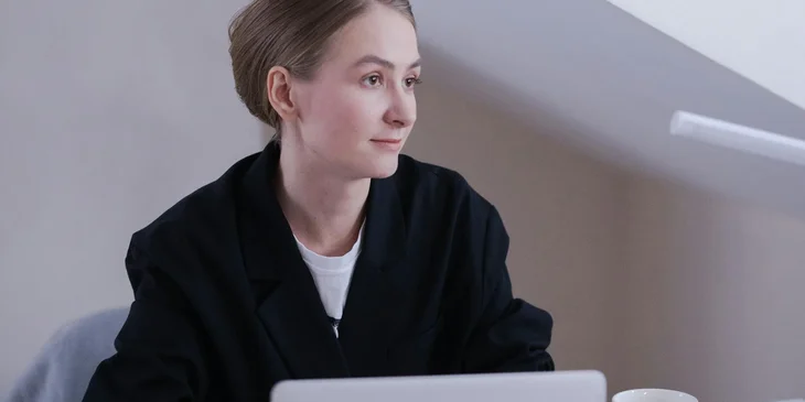 A woman in black blazer.