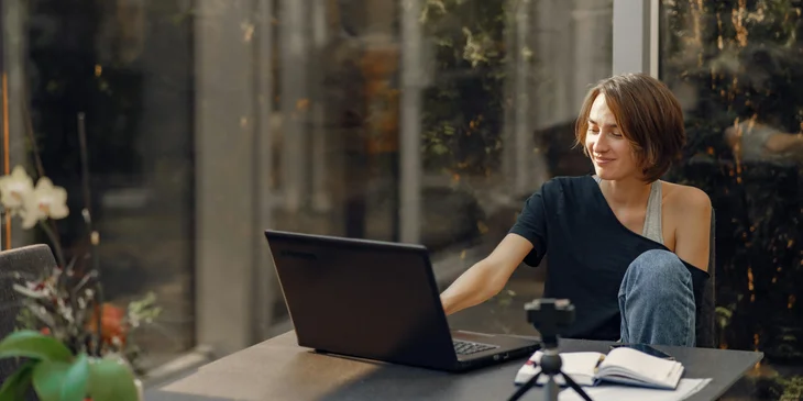 A woman working on a laptop.