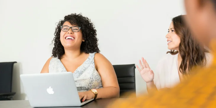 A woman sitting in front of a laptop.