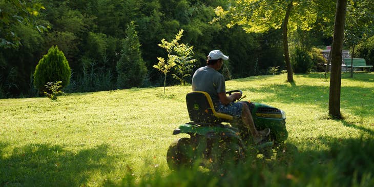 Person performing landscaping duties in a garden.