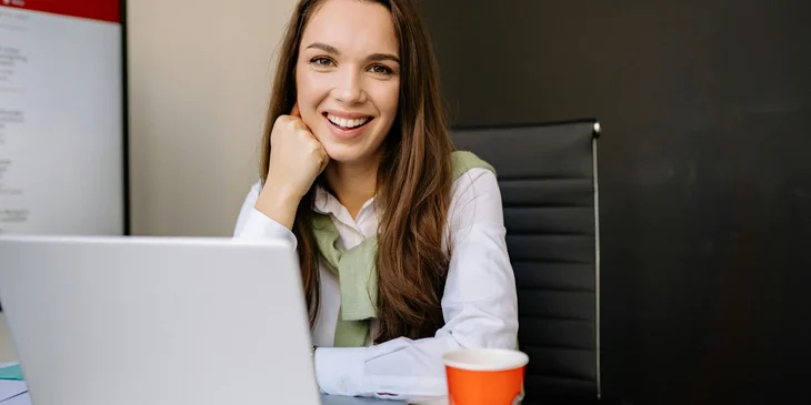 A lawyer wearing a white long sleeve polo and smiling.