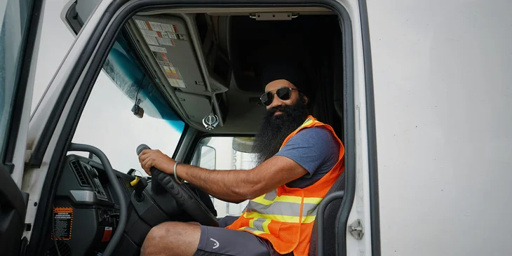 A truck driver smiling.