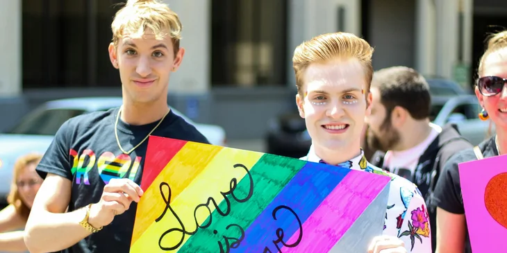 Members of the LGBTQ community holding a banner.