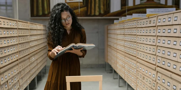 A library clerk reading a book to categorize it appropriately.
