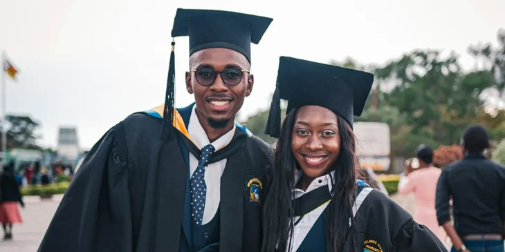 The students wearing academic gown standing.