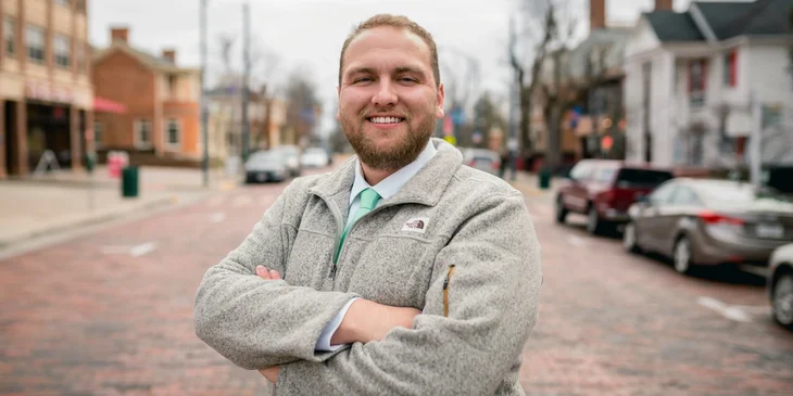 A man wearing a grey jacket.