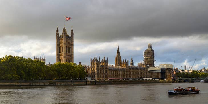 The Palace of Westminster in front of the Thames in London.