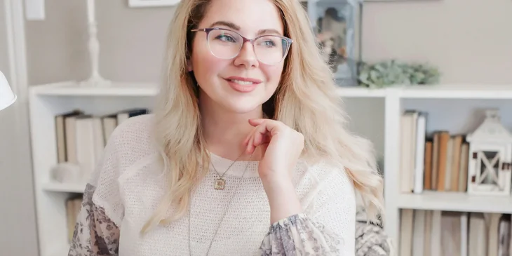A woman in white lace long sleeve shirt.