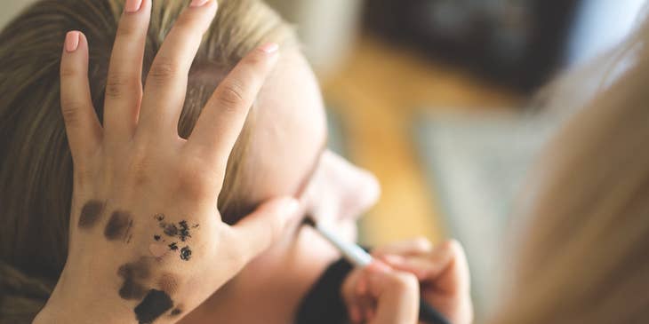 makeup artist applying eye shadow