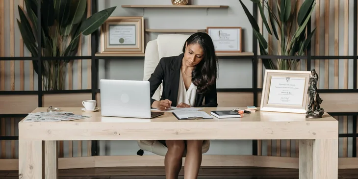 A woman diligently working at her desk.
