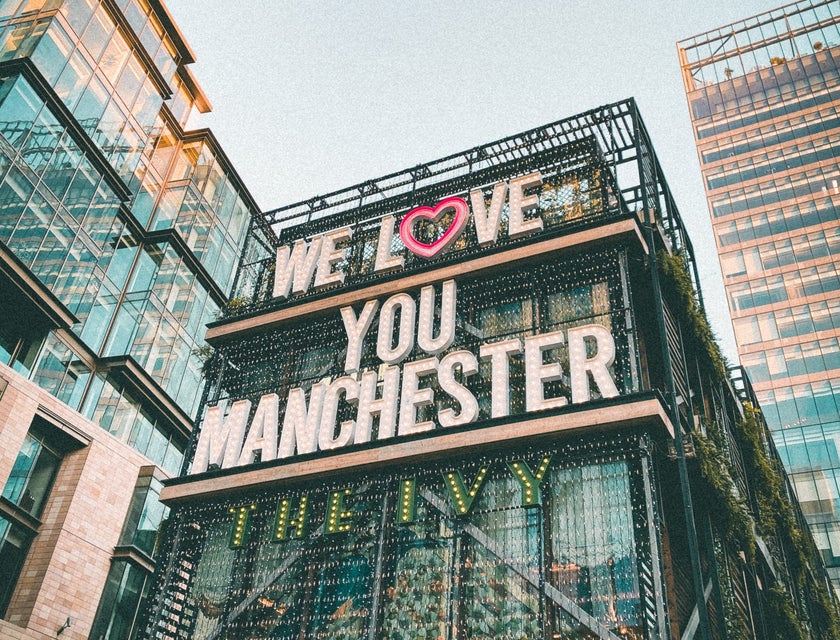 A view of a building in Manchester with a sign that says, "we love you Manchester."