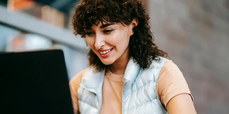 A woman working on her laptop.